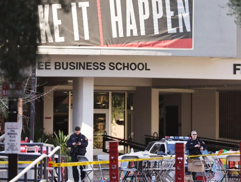 UNLV Shooting scene outside of the business school. Yellow caution tape around the building with some officers in the front.