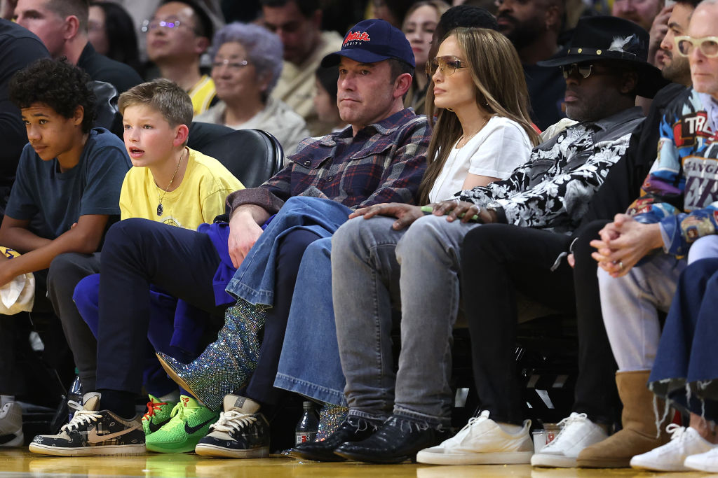 Actors Ben Affleck and Jennifer Lopez look on from the front row during the first half of a game between the Golden State Warriors and the Los Angeles Lakers.